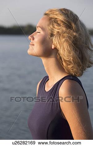 Beautiful woman with closed eyes standing in lake View Large Photo Image Stock Photo - Beautiful woman with closed eyes standing in lake. Fotosearch