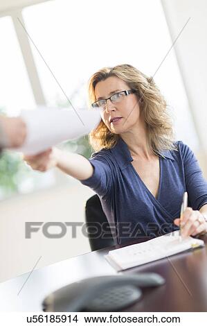 Business people exchanging documents View Large Photo Image Picture - Business people exchanging documents. Fotosearch