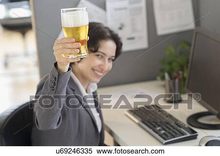 Business woman holding glass of beer View Large Photo Image Stock Photography - Business woman holding glass of beer. Fotosearch