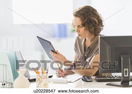 Business woman using digital tablet, laptop and computer View Large Photo Image Stock Photo - Business woman using digital tablet, laptop and computer. Fotosearch