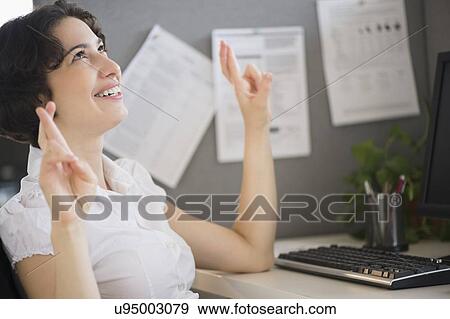 Businesswoman holding fingers crossed View Large Photo Image Stock Photo - Businesswoman holding fingers crossed. Fotosearch