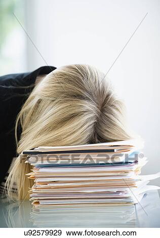 Businesswoman sleeping on stack of files View Large Photo Image Stock Photo - Businesswoman sleeping on stack of files. Fotosearch