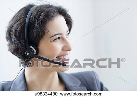 Businesswoman wearing headset View Large Photo Image Stock Image - Businesswoman wearing headset. Fotosearch