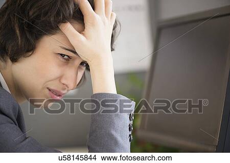 Businesswoman with head in hands View Large Photo Image Picture - Businesswoman with head in hands. Fotosearch