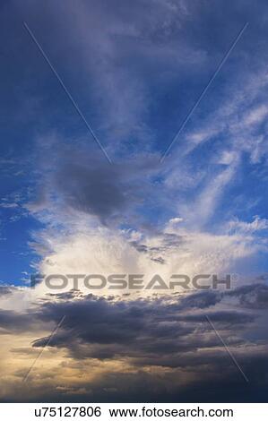 Stock Photograph - Clouds on blue sky. Fotosearch