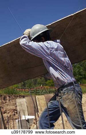 Construction worker working on construction site View Large Photo Image Stock Photo - Construction worker working on construction site. Fotosearch