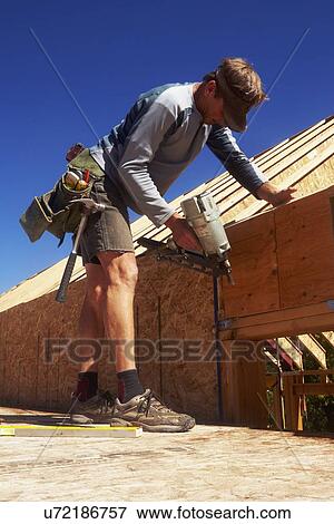 Stock Photo - Construction worker working on construction site. Fotosearch