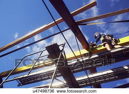 Construction worker working on construction site View Large Photo Image Stock Photograph - Construction worker working on construction site. Fotosearch