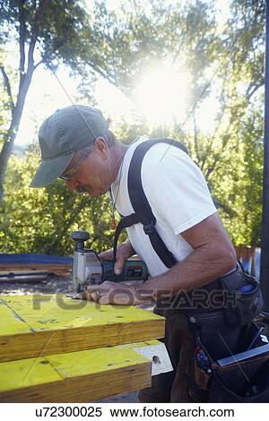 Stock Photography - Construction worker working on construction site. Fotosearch