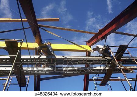 Picture - Construction workers working on construction site. Fotosearch