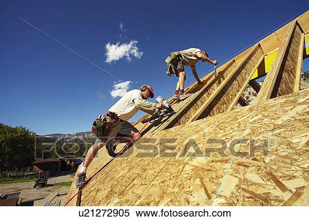 Stock Photography - Construction workers working on construction site. Fotosearch