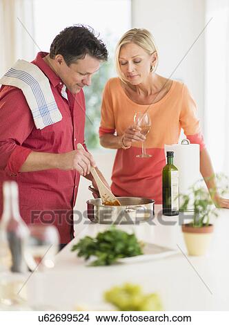 Picture - Couple cooking at home. Fotosearch