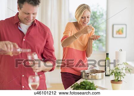 Couple cooking at home View Large Photo Image Stock Image - Couple cooking at home. Fotosearch