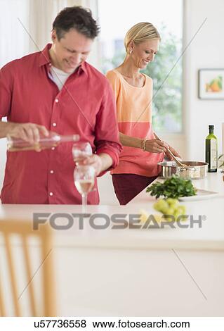 Couple cooking at home View Large Photo Image Stock Photo - Couple cooking at home. Fotosearch