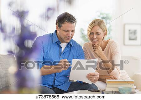 Stock Photography - Couple doing paperwork at home. Fotosearch