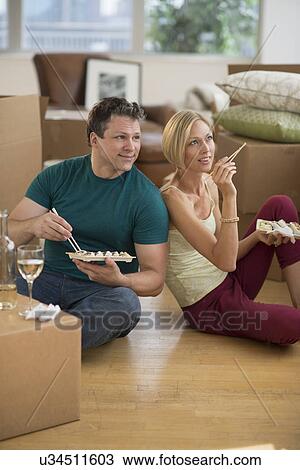 Couple eating sushi in new home View Large Photo Image Stock Image - Couple eating sushi in new home. Fotosearch