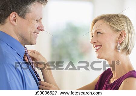 Stock Photo - Couple getting dressed together. Fotosearch