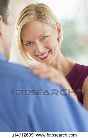 Couple in evening wear, focus on woman View Large Photo Image Stock Photo - Couple in evening wear, focus on woman. Fotosearch