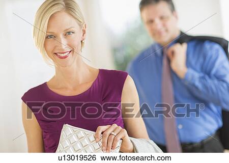 Couple in evening wear, focus on woman View Large Photo Image Stock Photograph - Couple in evening wear, focus on woman. Fotosearch