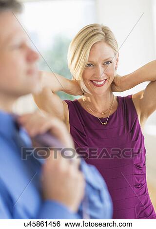 Stock Photograph - Couple in evening wear, focus on woman. Fotosearch