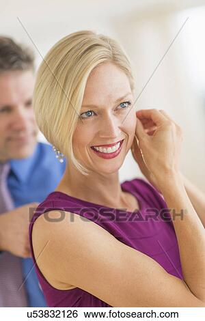 Stock Photograph - Couple in evening wear, focus on woman. Fotosearch