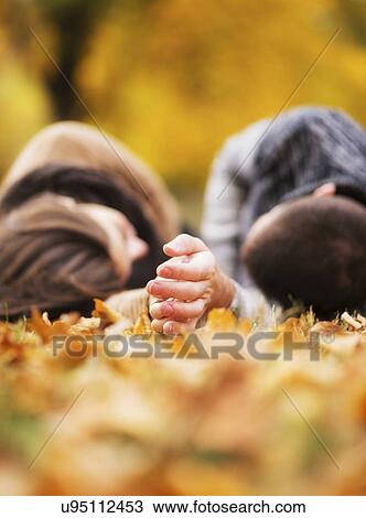 Couple lying down in Central Park View Large Photo Image Stock Image - Couple lying down in Central Park. Fotosearch