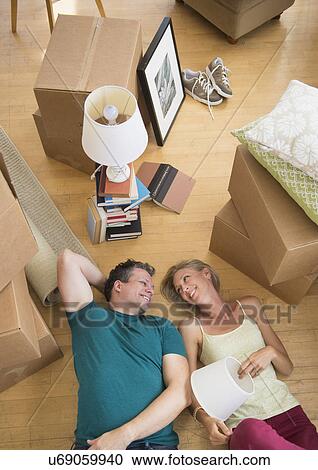 Couple lying on floor of new home View Large Photo Image Stock Image - Couple lying on floor of new home. Fotosearch