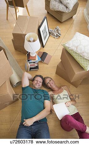Stock Photo - Couple lying on floor of new home. Fotosearch