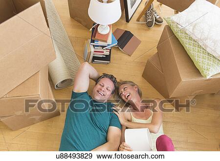 Couple lying on floor of new home View Large Photo Image Stock Photo - Couple lying on floor of new home. Fotosearch