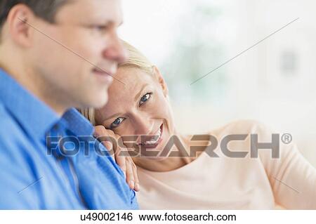 Couple relaxing, focus on woman View Large Photo Image Stock Photograph - Couple relaxing, focus on woman. Fotosearch