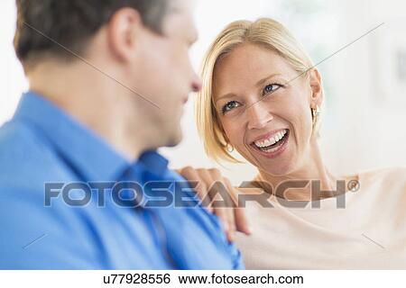 Couple relaxing, focus on woman View Large Photo Image Stock Photograph - Couple relaxing, focus on woman. Fotosearch