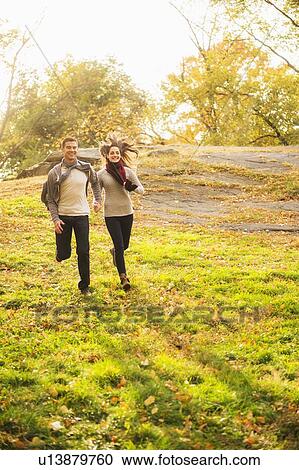 Stock Image - Couple running in Central Park. Fotosearch