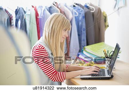 Creative professional using laptop in studio View Large Photo Image Stock Image - Creative professional using laptop in studio. Fotosearch