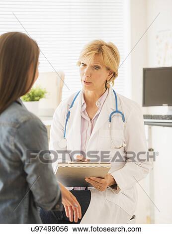 Stock Photograph - Doctor and patient talking. Fotosearch