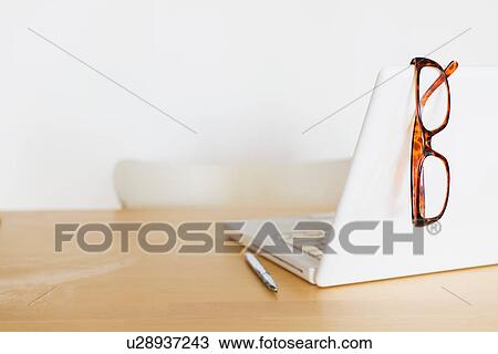 Eyeglasses on laptop View Large Photo Image Stock Image - Eyeglasses on laptop. Fotosearch