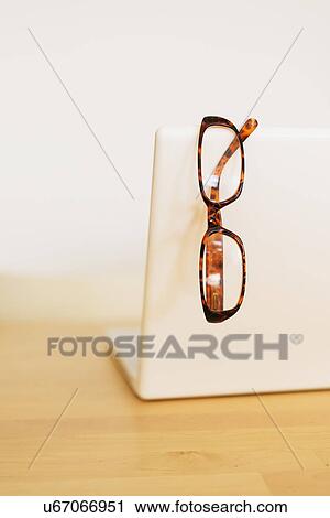 Eyeglasses on laptop View Large Photo Image Stock Image - Eyeglasses on laptop. Fotosearch