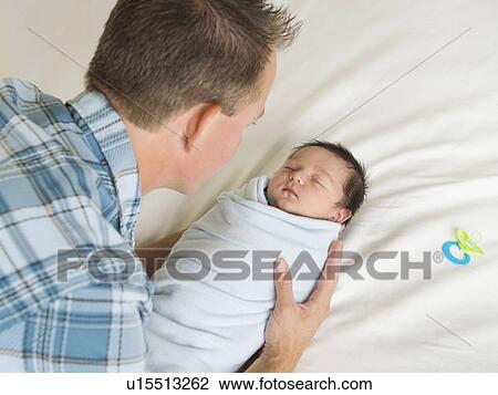 Father holding newborn son (0-11 months) View Large Photo Image Stock Image - Father holding newborn son (0-11 months). Fotosearch