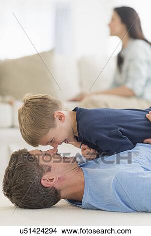 Picture - Father with son (6-7) playing at home. Fotosearch