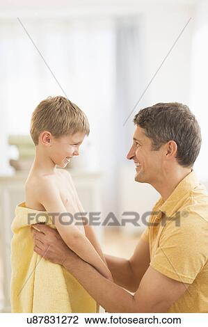 Father with son (6-7) wrapped in towel View Large Photo Image Stock Image - Father with son (6-7) wrapped in towel. Fotosearch