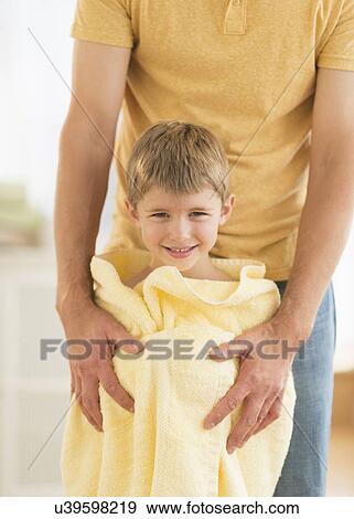 Father with son (6-7) wrapped in towel View Large Photo Image Stock Photo - Father with son (6-7) wrapped in towel. Fotosearch