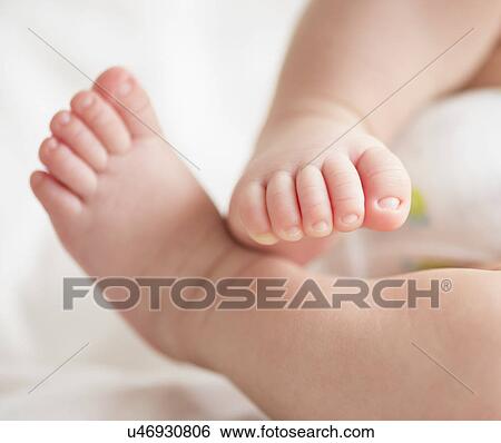Stock Photograph - Feet of baby boy (2-5 months). Fotosearch