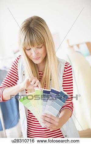 Stock Photograph - Female designer holding color swatch. Fotosearch