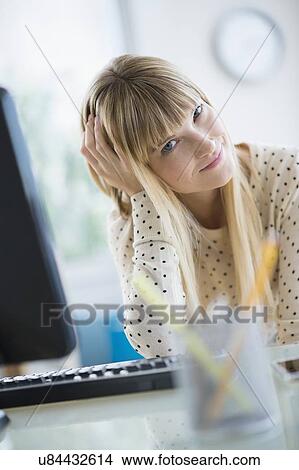 Picture - Female designer relaxing in office. Fotosearch