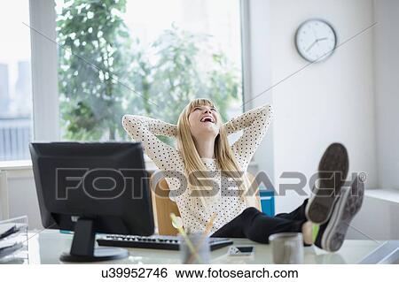 Female designer relaxing in office View Large Photo Image Stock Photograph - Female designer relaxing in office. Fotosearch