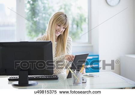 Female designer working in office View Large Photo Image Stock Photography - Female designer working in office. Fotosearch
