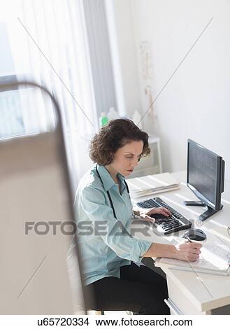 Female doctor doing notes View Large Photo Image Picture - Female doctor doing notes. Fotosearch