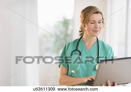 Female doctor using laptop View Large Photo Image Stock Photo - Female doctor using laptop. Fotosearch