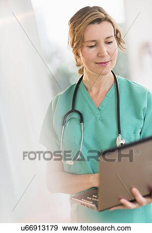 Female doctor using laptop View Large Photo Image Stock Photo - Female doctor using laptop. Fotosearch