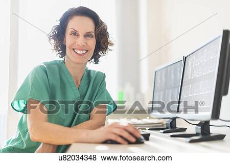 Stock Photo - Female technician working on computer. Fotosearch