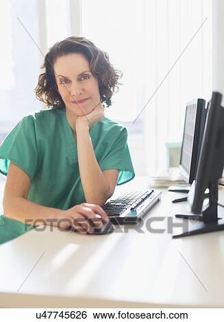 Female technician working on computer View Large Photo Image Stock Photograph - Female technician working on computer. Fotosearch